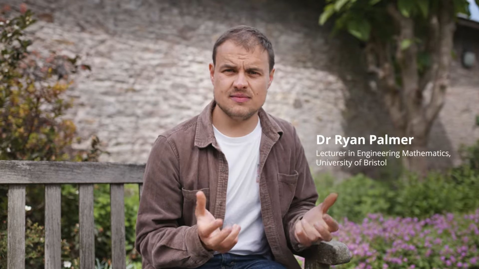 Dr Ryan Palmer talking on a bench